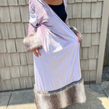 A woman wearing the Blush Velvet Faux Fur Jacket by Jennafer Grace with a black dress and brown boots.