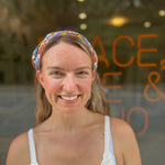 A woman wearing the Handmade Granny Square Crochet Headband around her head.