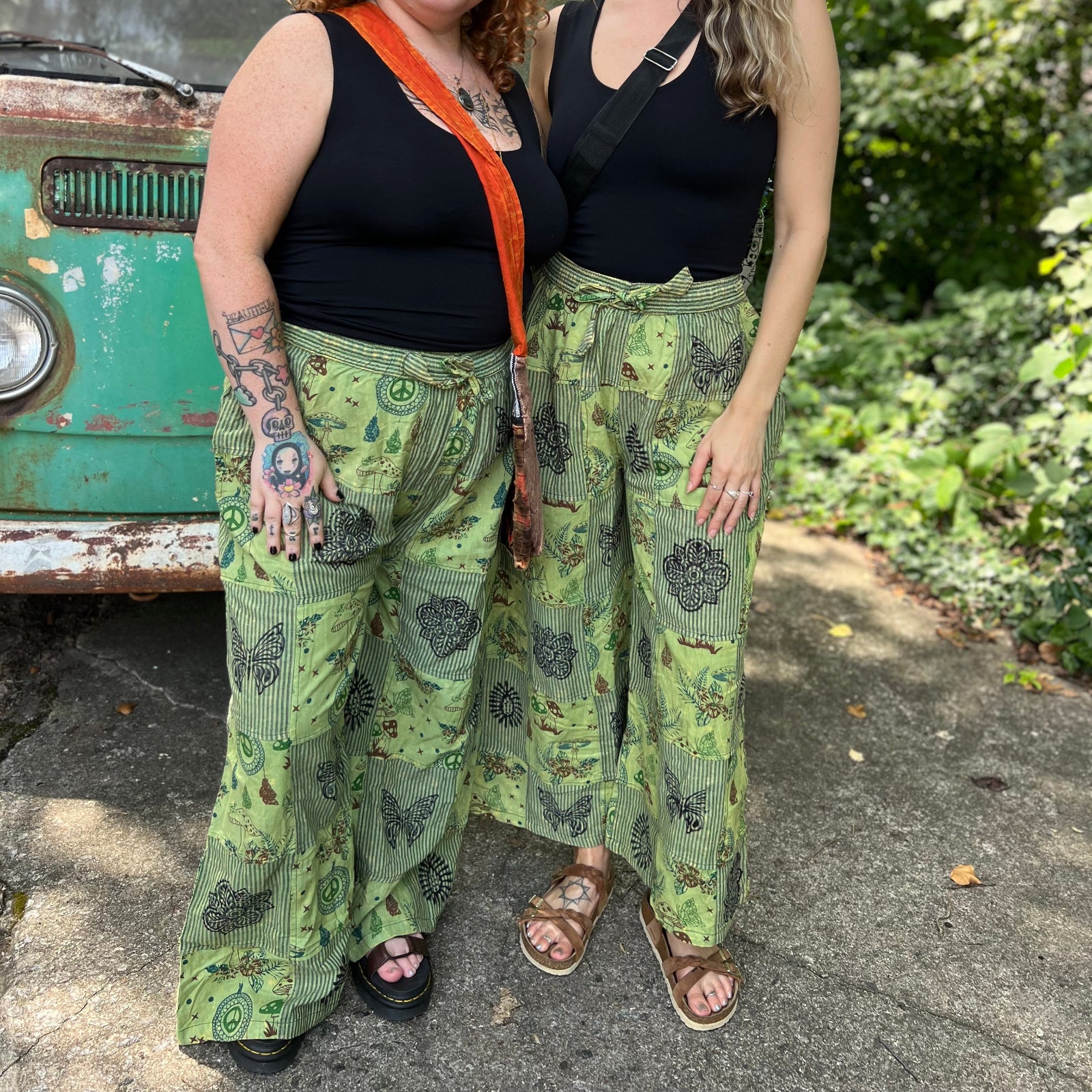 Two women wearing the Green Patch Cotton Palazzo Pants in front of a vintage Volkswagen bus.