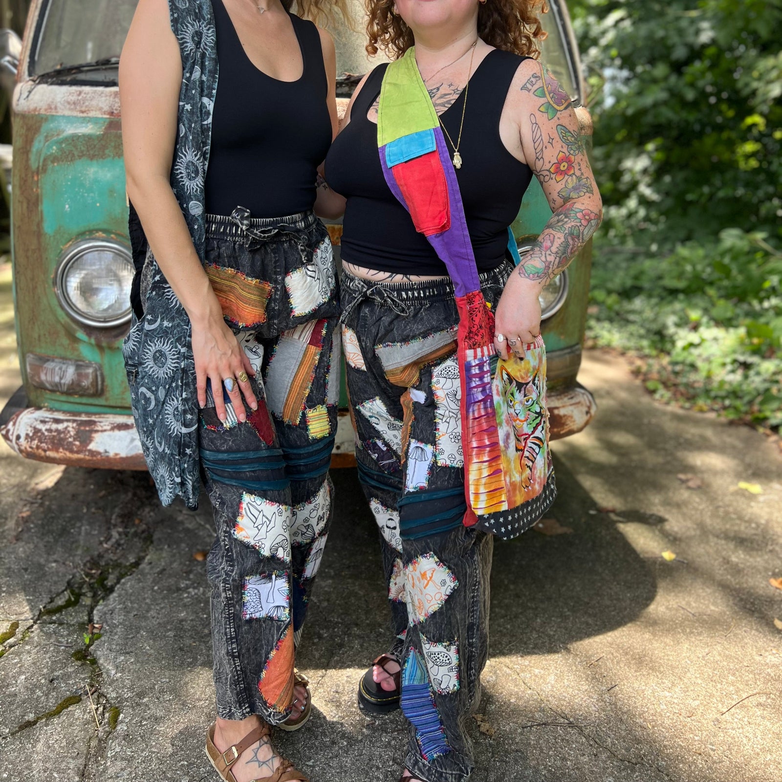 Two women wearing the Multi Patch Hippie Gypsy Cotton Trousers in front of a vintage Volkswagen bus.