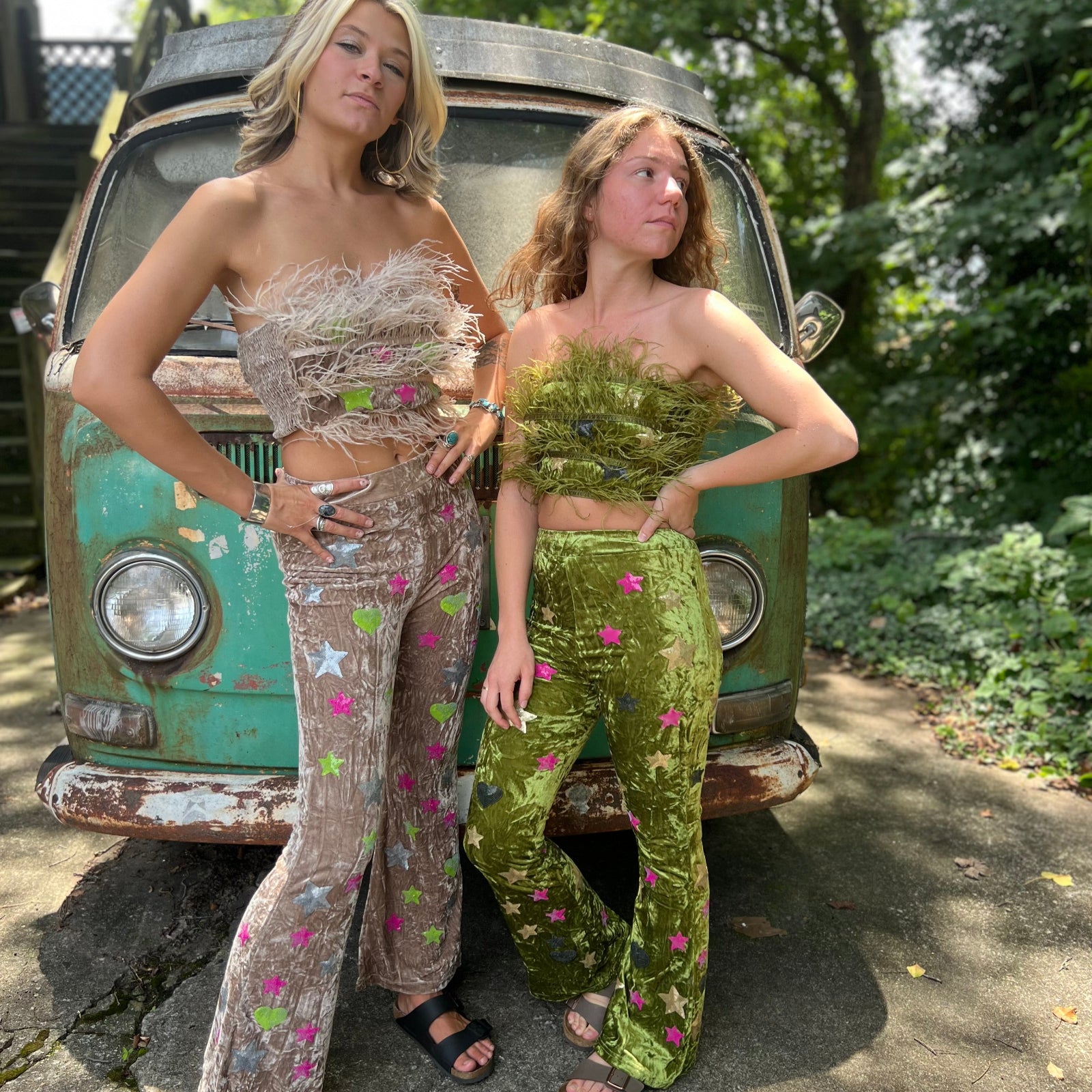 Two women wearing the beige and green Feather Crop Top with Stretch Flared Pants Set in front of a vintage teal Volkswagen bus.