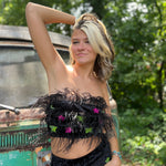 A woman wearing the black Feather Crop Top with Stretch Flared Pants Set in front of a vintage teal Volkswagen bus.