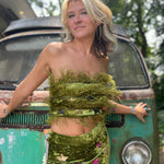 A woman wearing the moss green Feather Crop Top with Stretch Flared Pants Set in front of a vintage teal Volkswagen bus.