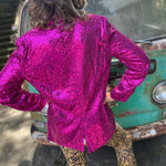 Someone wearing the Sequin Boyfriend Single Hot Pink Blazer in front of a vintage teal Volkswagen bus.