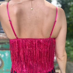 A woman wearing the hot pink Sequin Tiered Fringe Cami Tank in front of a teal vintage Volkswagen bus.