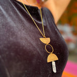 Someone wearing the Just a Phase Necklace with a black top.