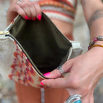 A woman holding the Mid Century Modern Traveller Large Pouch open, showing off the inside.