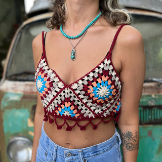 Someone wearing the Handmade Bohemian Crochet Design Cropped Camisole in front of an old teal Volkswagen bus.