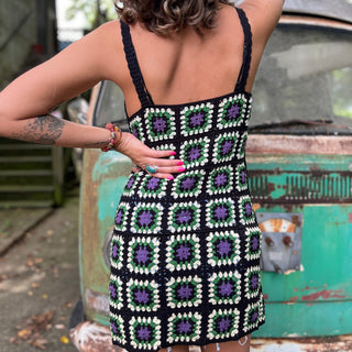 Someone wearing the black Sleeveless Knit Tank Dress in front of an old teal Volkswagen bus.