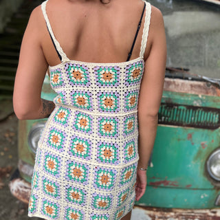 Someone wearing the beige Sleeveless Knit Tank Dress in front of an old teal Volkswagen bus.