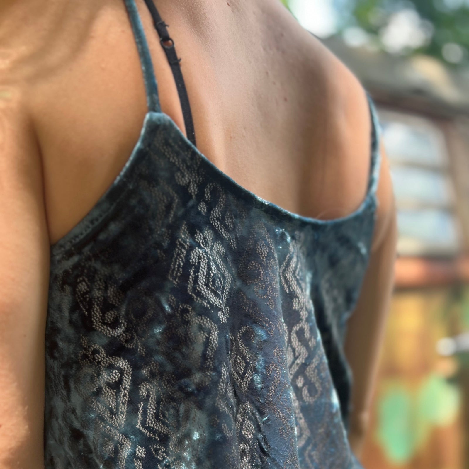 Someone wearing the Teal Spaghetti Strap Velvet Flowy Tank Top.