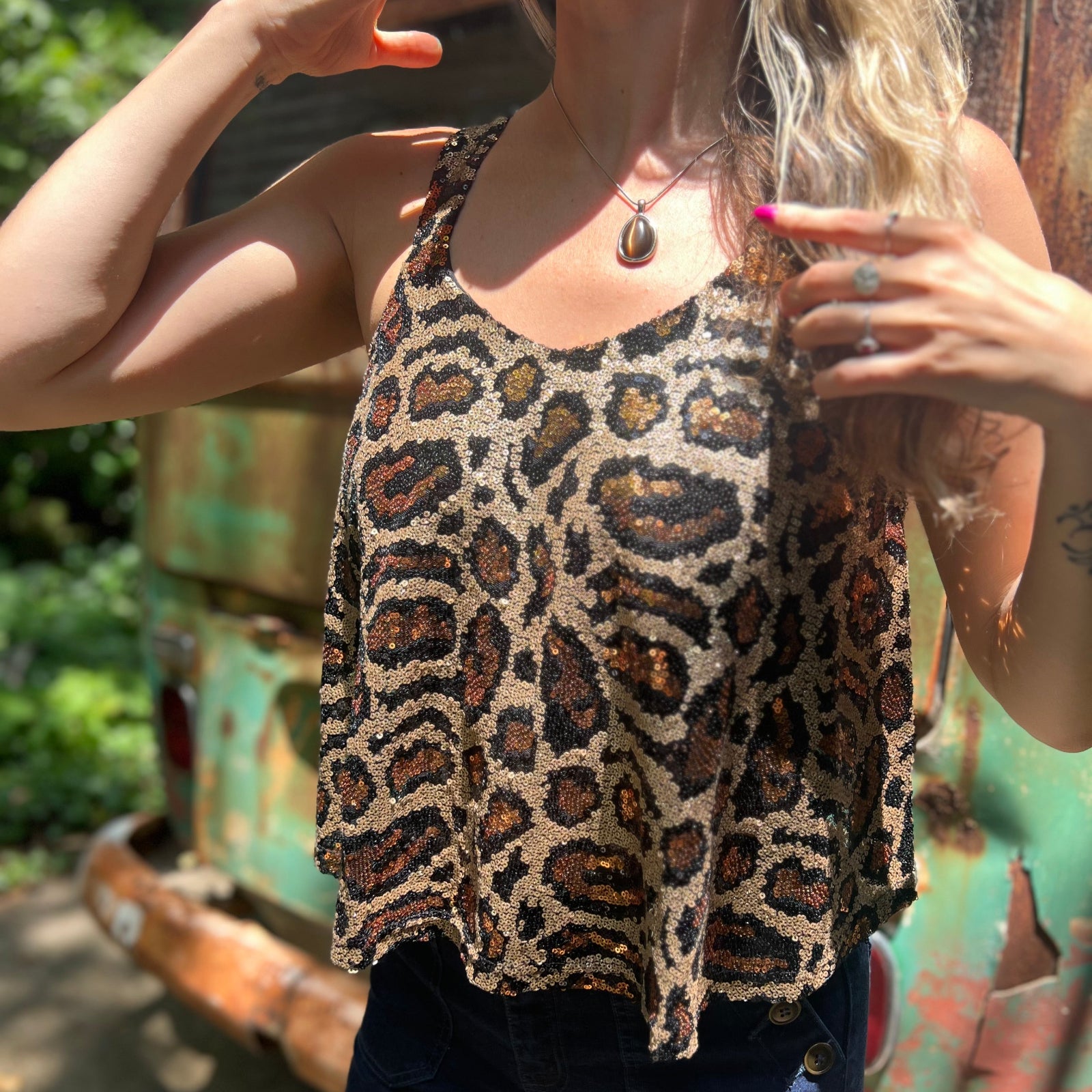 Someone wearing the Gold Cheetah Animal Print Flowy Sequin Tank.