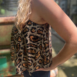 Someone wearing the Gold Cheetah Animal Print Flowy Sequin Tank.