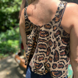 Someone wearing the Gold Cheetah Animal Print Flowy Sequin Tank.