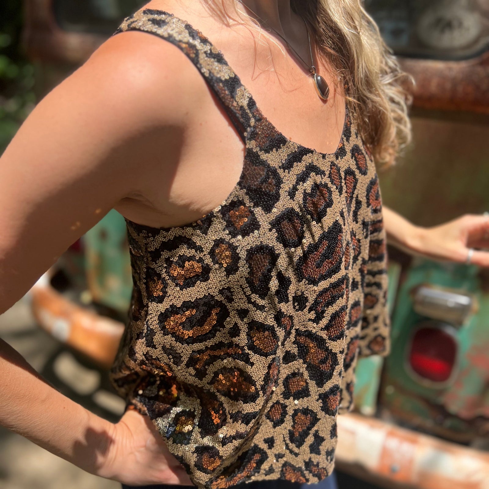 Someone wearing the Gold Cheetah Animal Print Flowy Sequin Tank.
