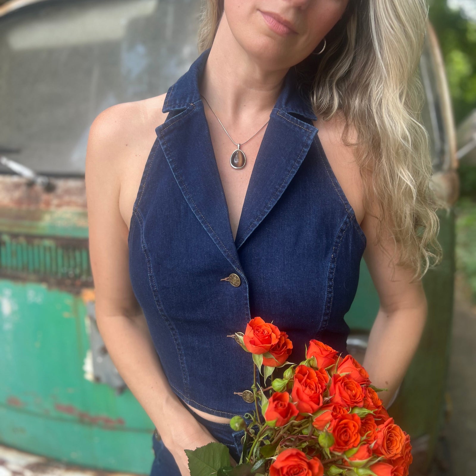 Someone wearing the Dark Wash Halter Neck Denim Vest.