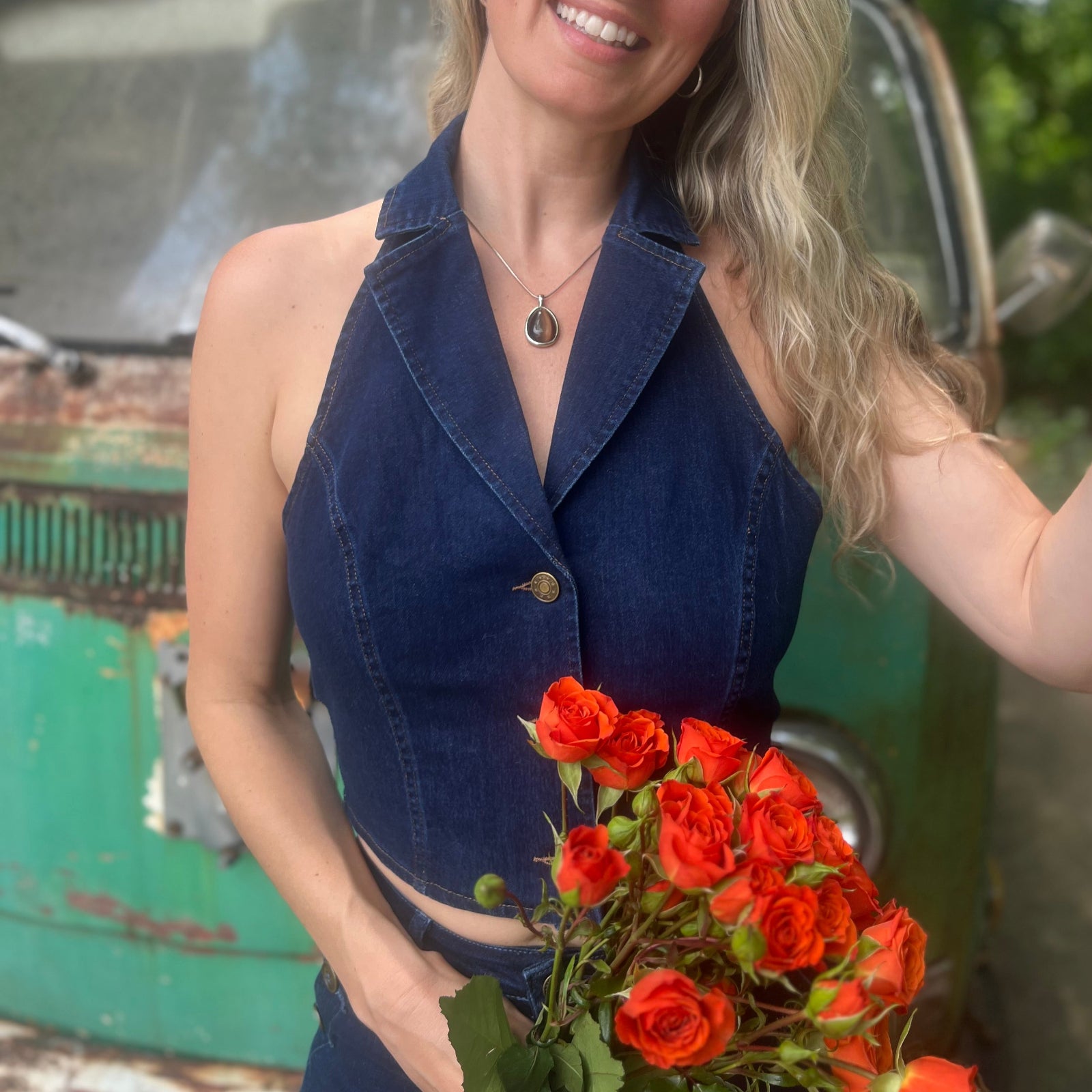 Someone wearing the Dark Wash Halter Neck Denim Vest.