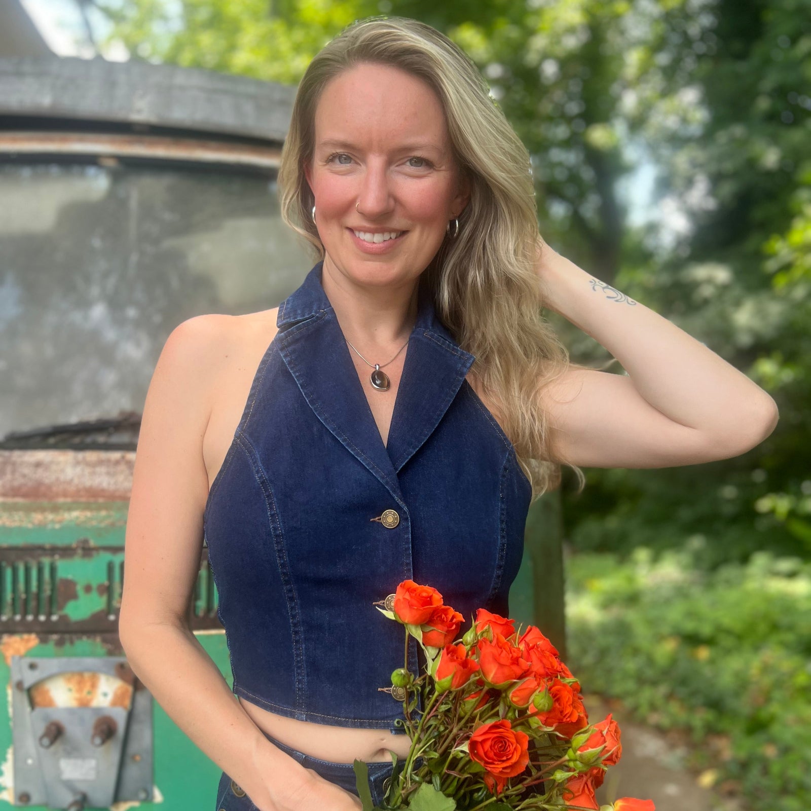 Someone wearing the Dark Wash Halter Neck Denim Vest.