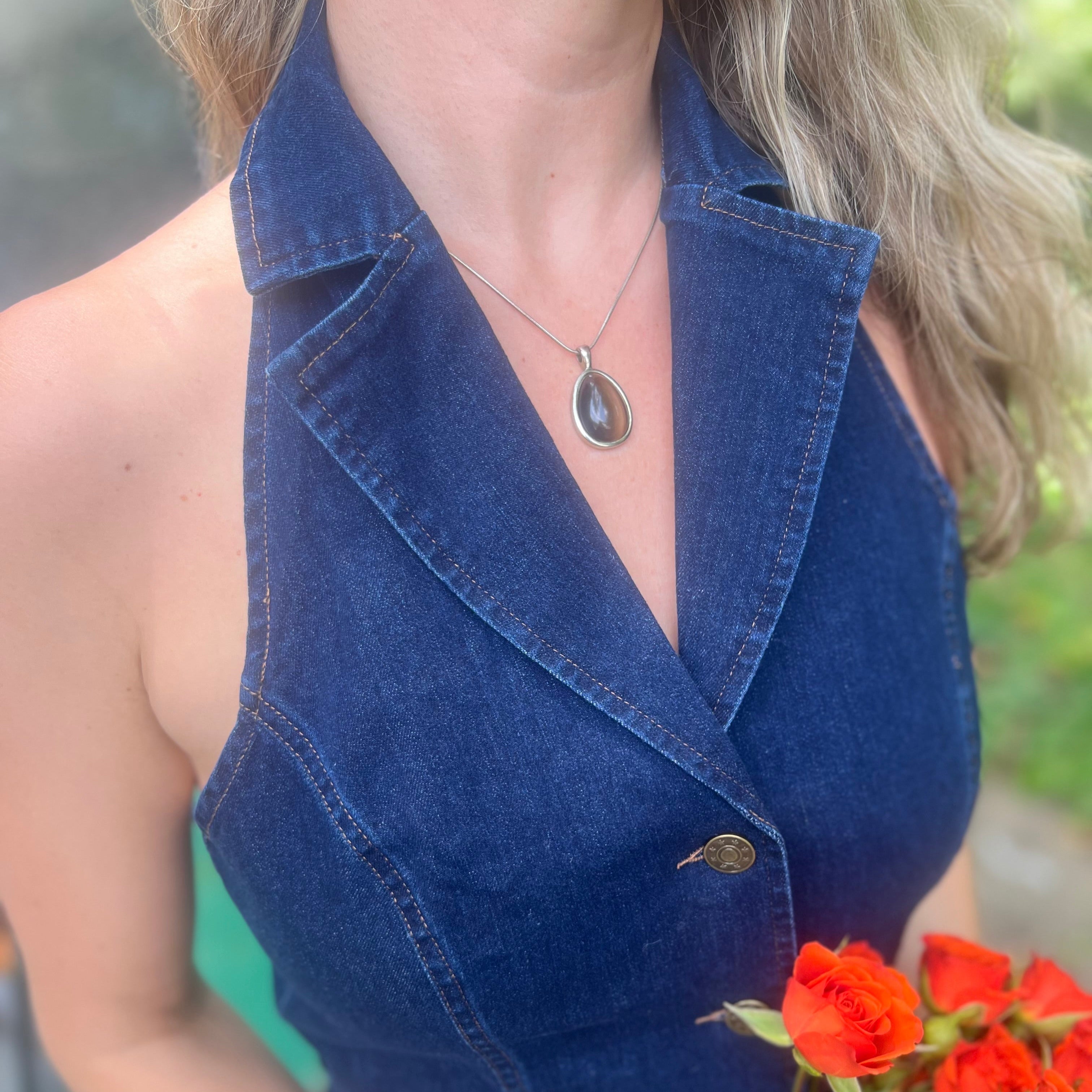Someone wearing the Dark Wash Halter Neck Denim Vest.