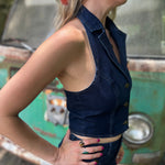 Someone wearing the Dark Wash Halter Neck Denim Vest.