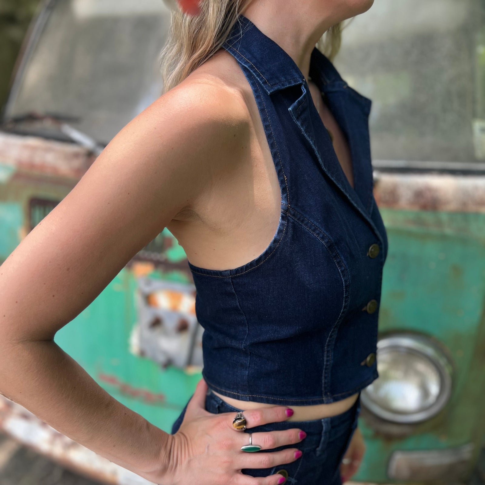 Someone wearing the Dark Wash Halter Neck Denim Vest.