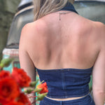 Someone wearing the Dark Wash Halter Neck Denim Vest.