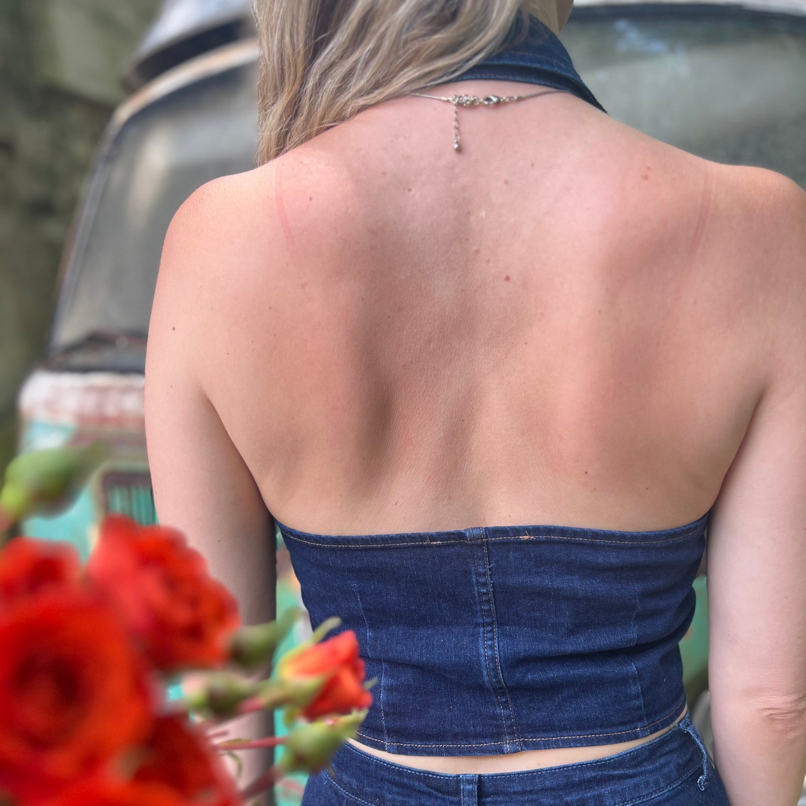 Someone wearing the Dark Wash Halter Neck Denim Vest.