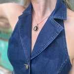 Someone wearing the Dark Wash Halter Neck Denim Vest.