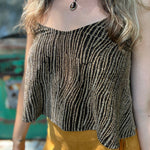 A woman wearing the Gold Spaghetti Strap Glitter Flowy Tank.