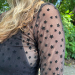 A woman wearing the Star Flocking Sheer Mesh Top.