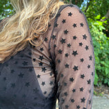 A woman wearing the Star Flocking Sheer Mesh Top.
