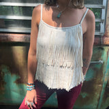 A woman wearing the Cream Fringe Faux Suede Cami with wine bell bottoms.