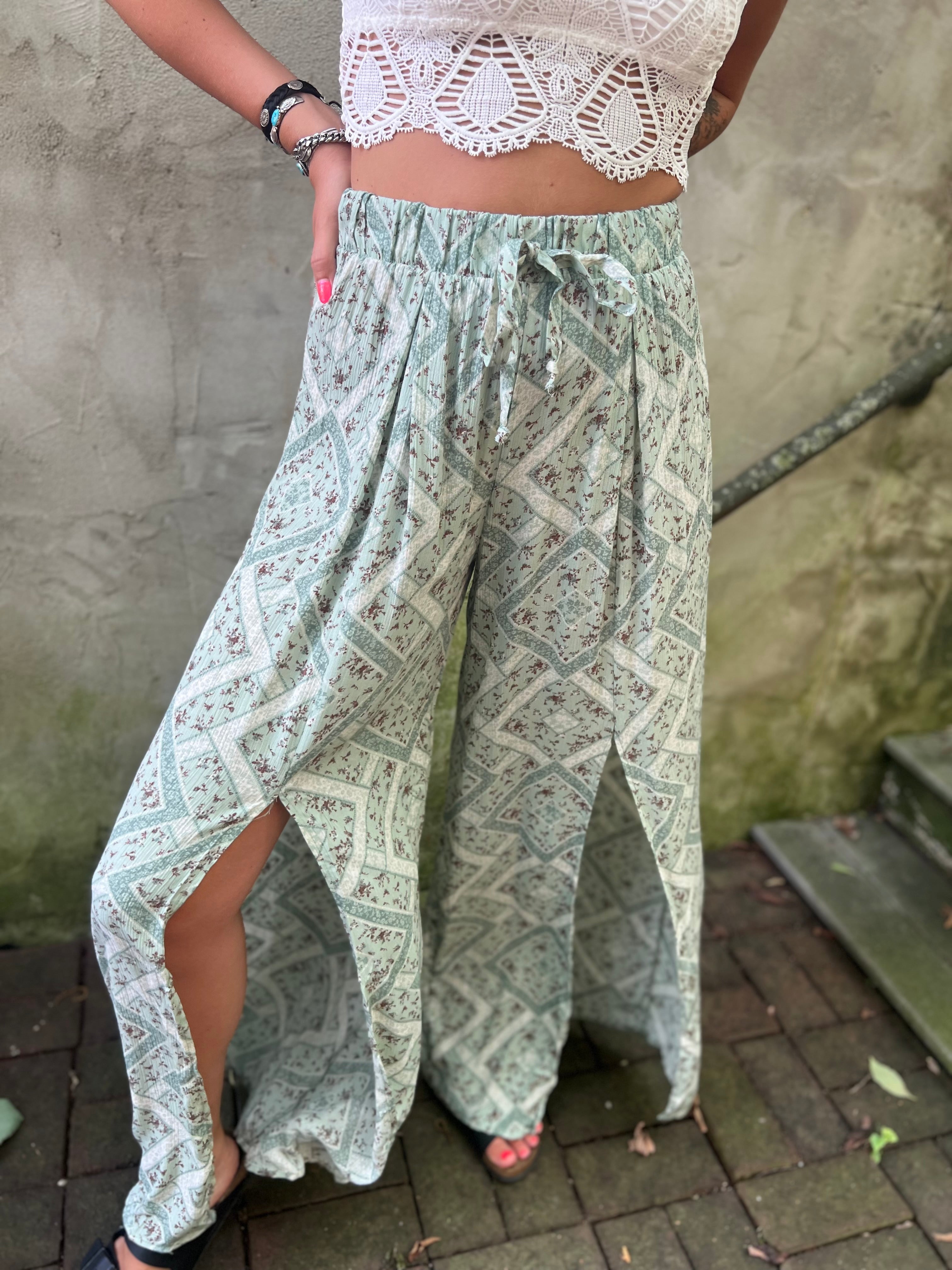 A woman wearing the Sage Linen Pants with Front Slit and a white bralette.