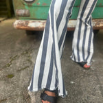 A woman wearing the Cream and Grey Striped Distressed Denim Bell Bottoms