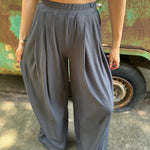 A woman wearing the Charcoal Ribbed Wide Leg Pants with Side Pockets with a cream crochet top.