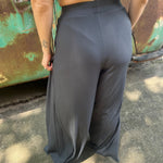 A woman wearing the Charcoal Ribbed Wide Leg Pants with Side Pockets with a cream crochet top.