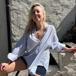 A woman wearing the Striped Button Down Long Sleeve Shirt Top.