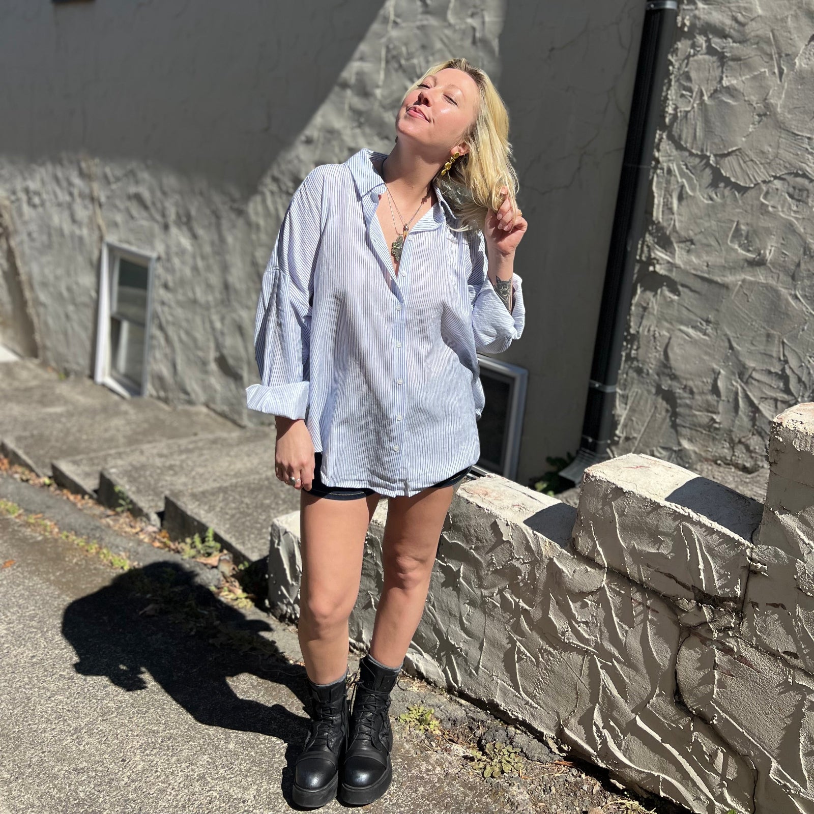 A woman wearing the Striped Button Down Long Sleeve Shirt Top.