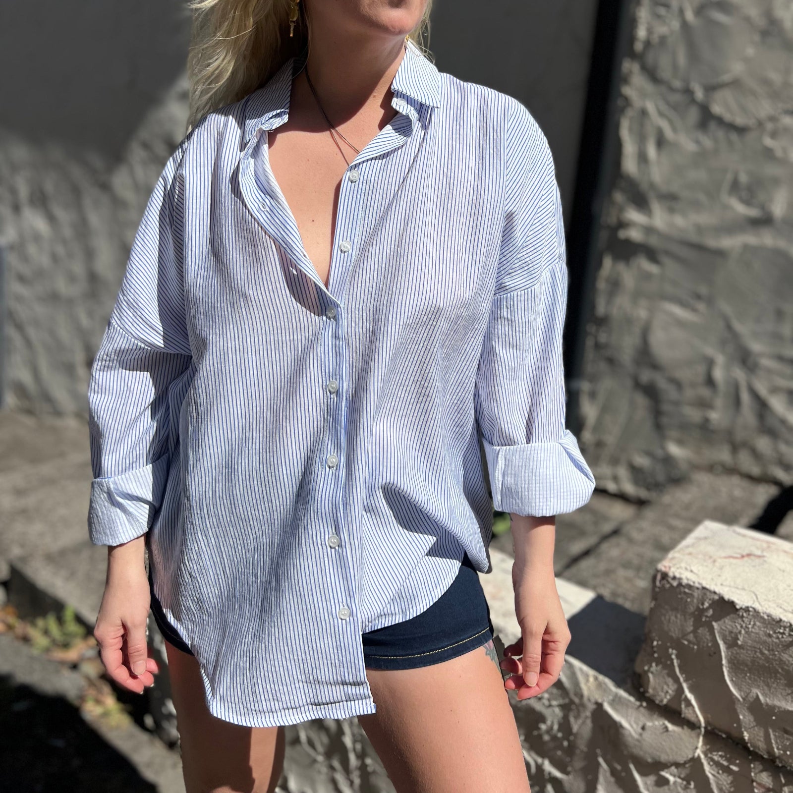 A woman wearing the Striped Button Down Long Sleeve Shirt Top.