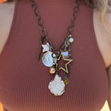 A woman wearing the Gypsy Junk Original Dutton 24" Necklace with a mauve tank.