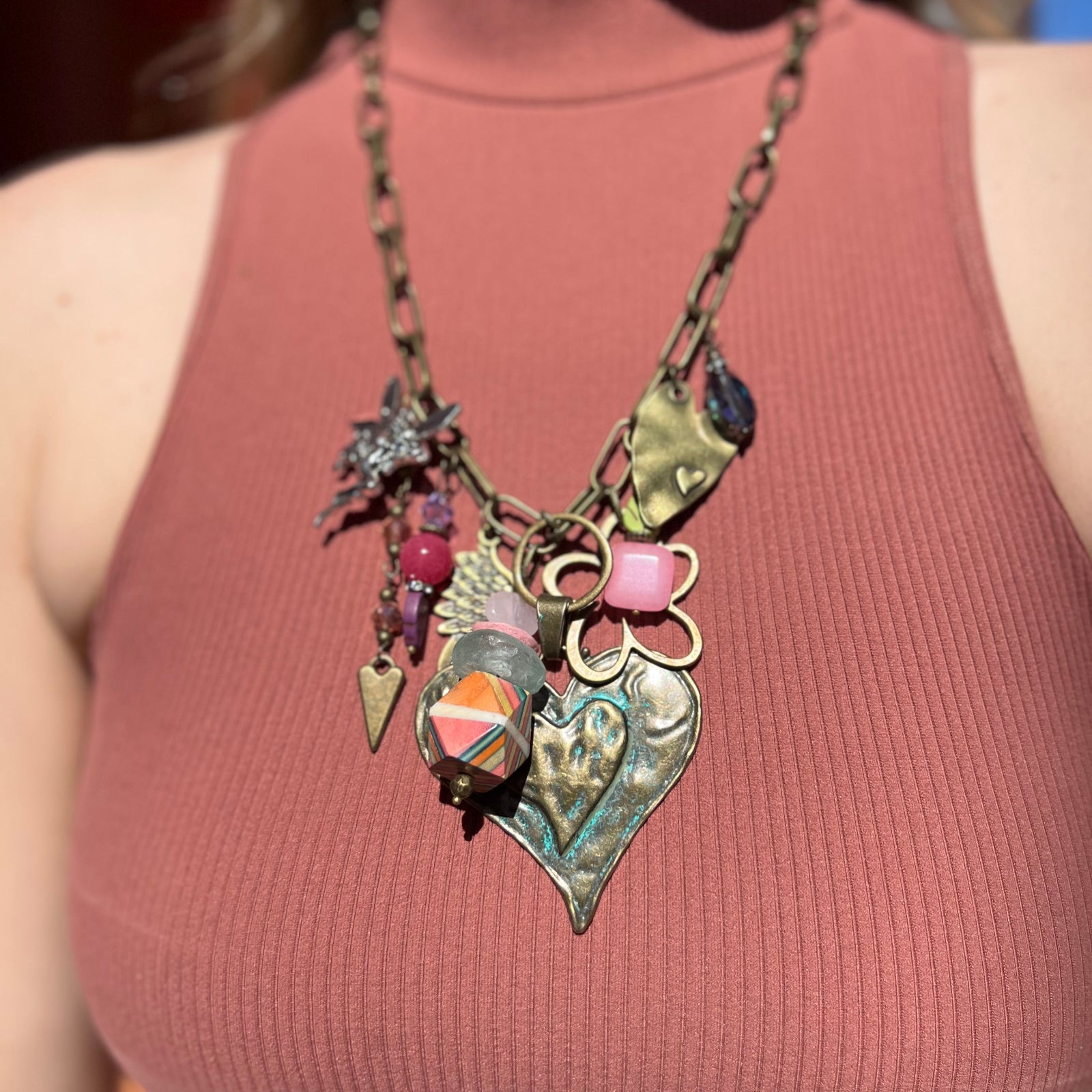 A woman wearing the Gypsy Junk Original-Heart Sorbet 24" Necklace with a mauve tank.