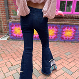 A woman wearing the Dark Denim Bellbottoms with Embroidery Detail.