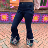 A woman wearing the Dark Denim Bellbottoms with Embroidery Detail.