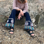 A woman wearing the Dark Denim Bellbottoms with Embroidery Detail.