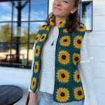 A woman wearing the Sunflower Flower Granny Square Fleece Lined Wool Vest with a white sweater and jeans.
