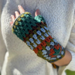 Someone wearing the Turquoise Granny Square Pure Wool Fingerless Mitten Gloves for Women.