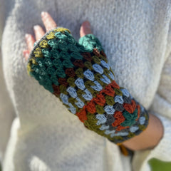 Someone wearing the Turquoise Granny Square Pure Wool Fingerless Mitten Gloves for Women.