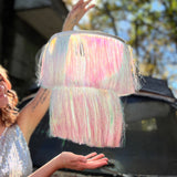 A woman in a silver dress holding the Iridescent Fringe Party Chandelier.