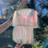 A woman holding the Iridescent Fringe Party Chandelier.