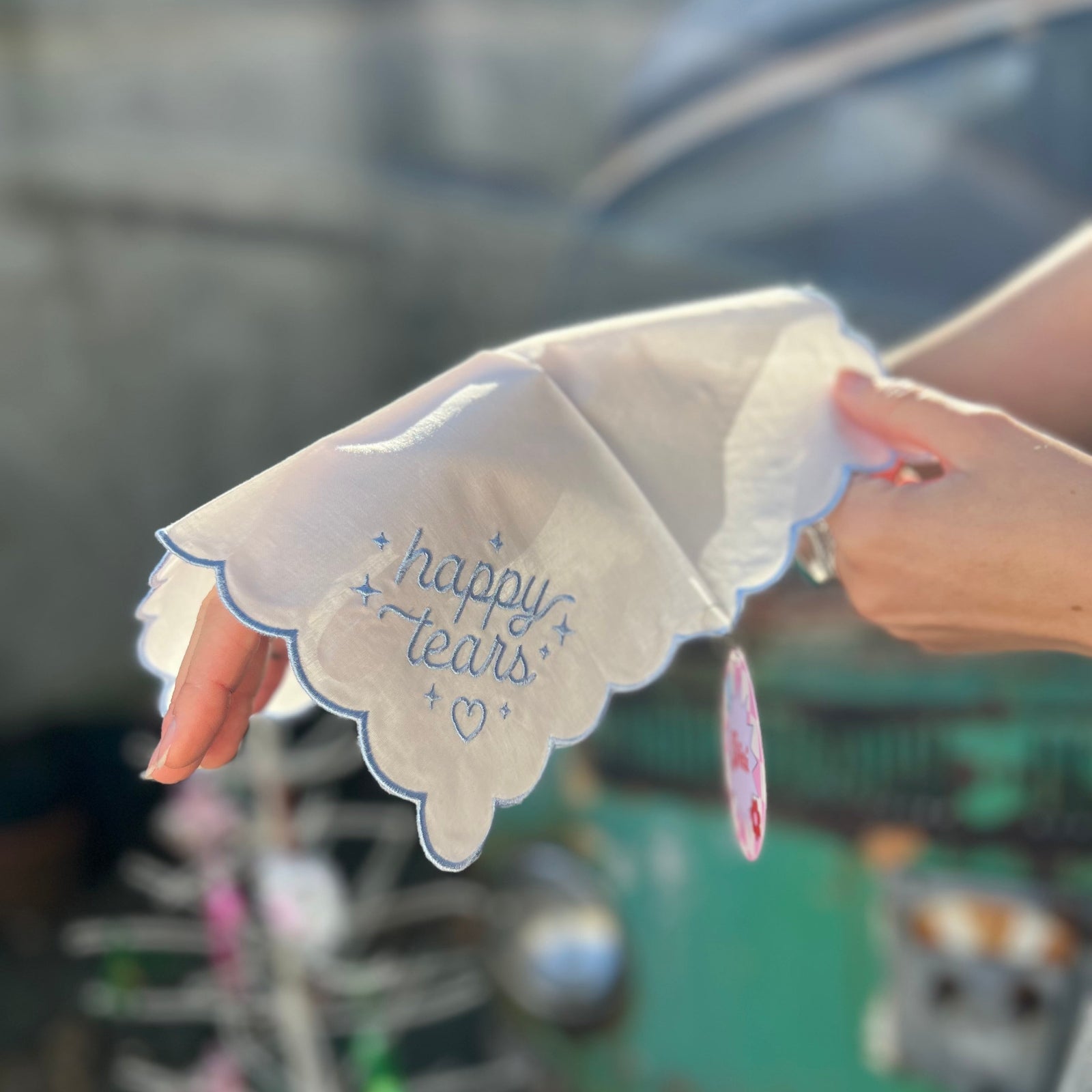 Someone holding the Happy Tears Embroidered Handkerchief.
